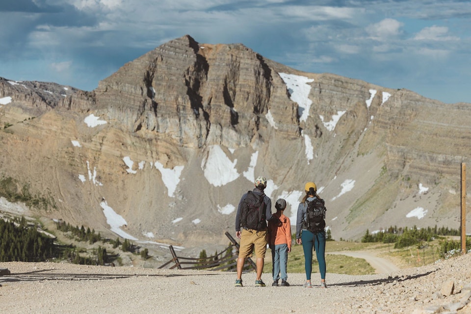 Three people looking at Cody Peak
