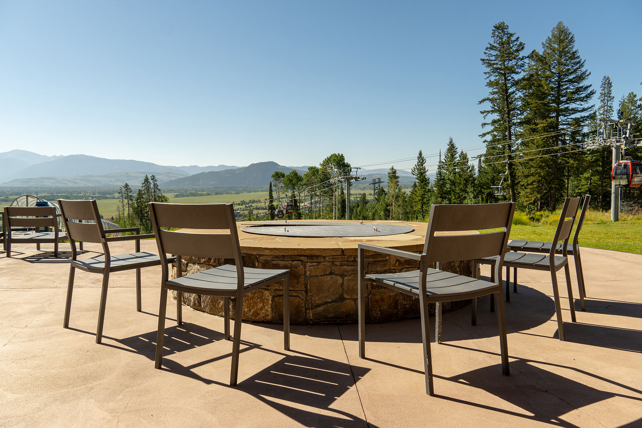 chairs around a fire pit at Solitude Station in the summer