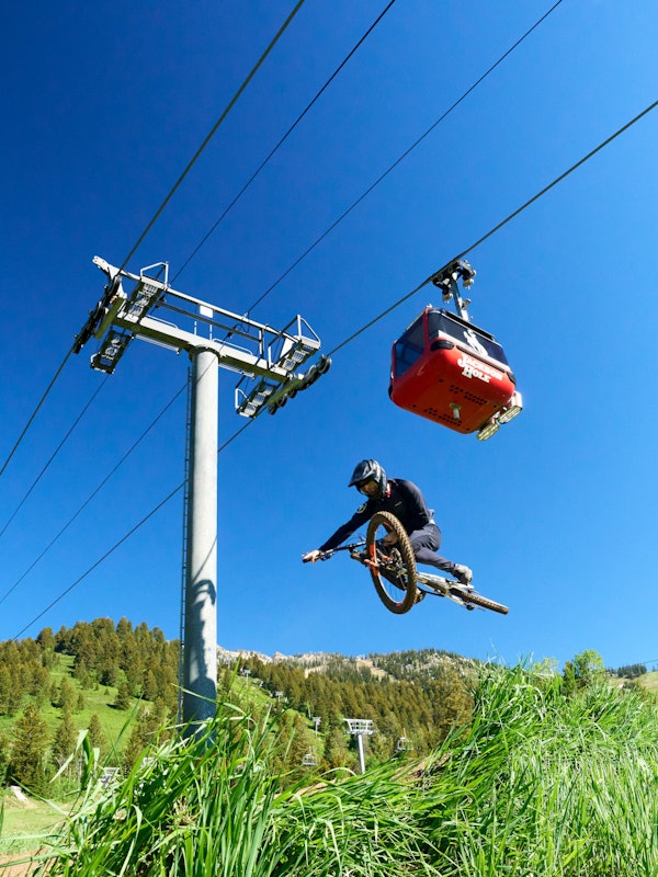 getting air in the bike park with the gondola flying above