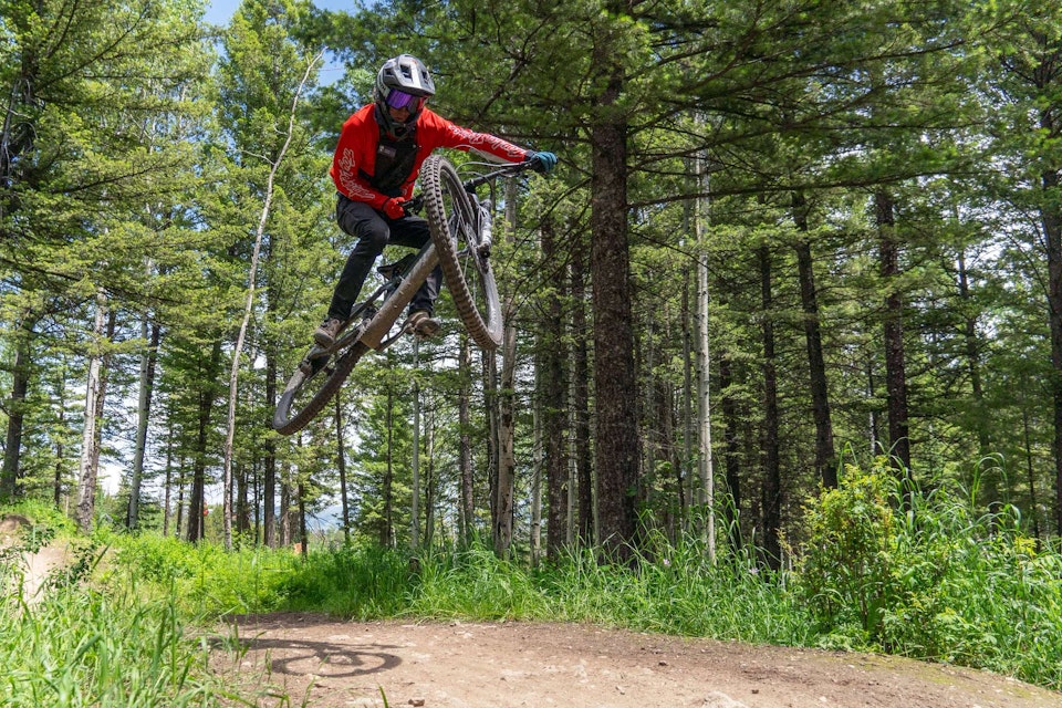a bike park guide getting air in the bike park