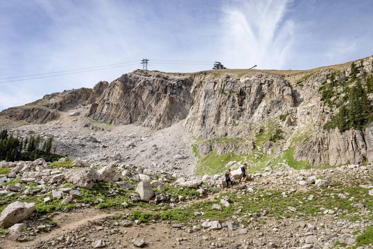Two hikers with the Aerial Tram line in the background