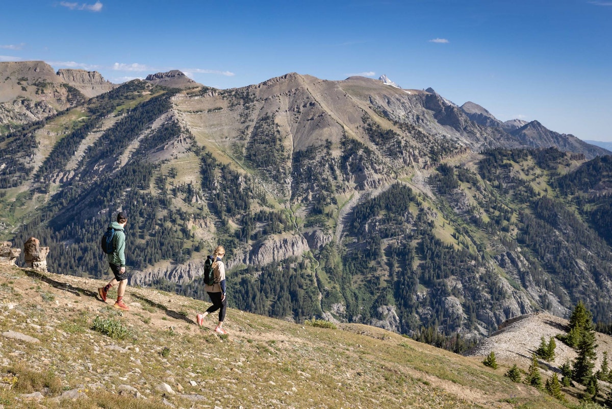 Two hikers looking out at beautiful views while they walk