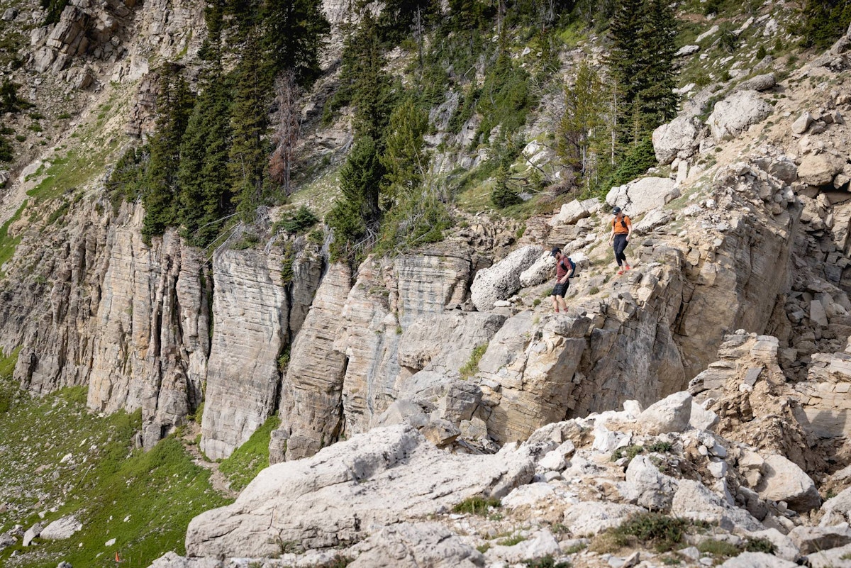 Two hikers on a steep, rocky section of the North Ridge Trail