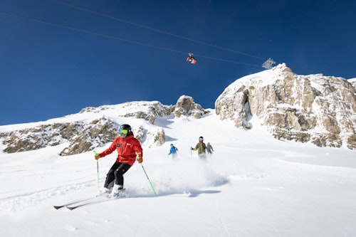 An instructor teaching a lesson with Corbet's Couloir in background