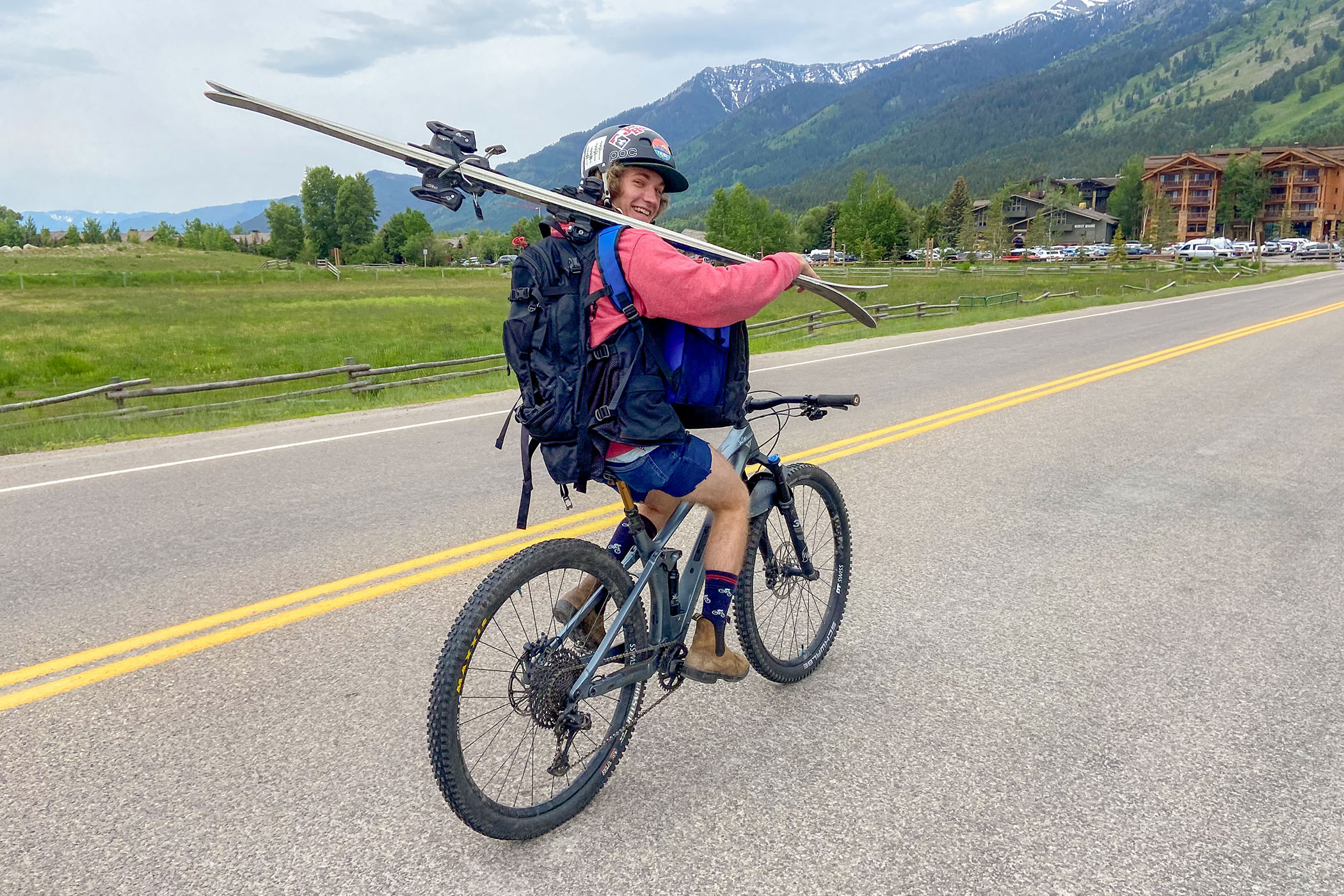 Person biking to Teton Village carrying skis