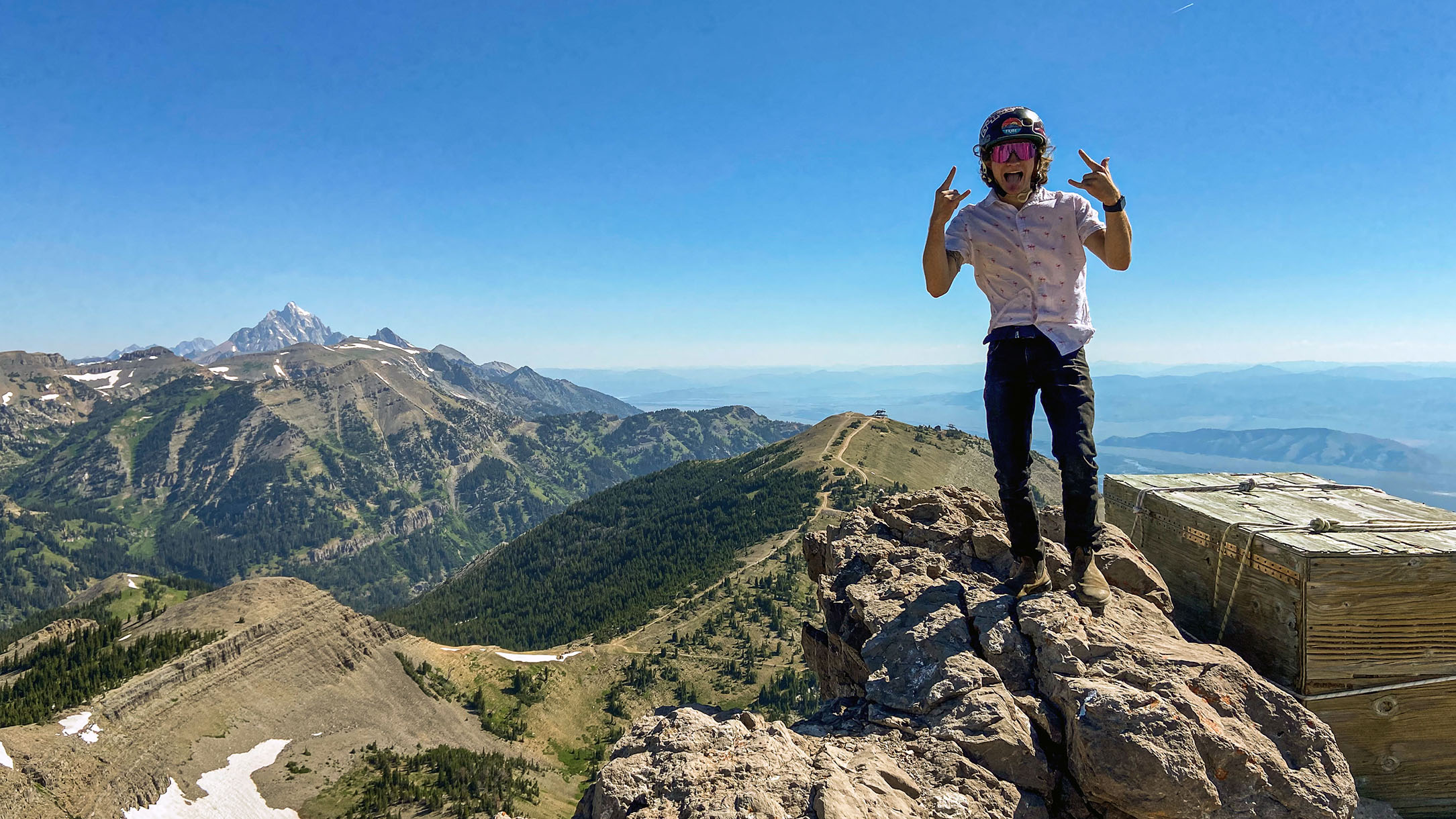 Man standing on top of Cody Peak in the summer