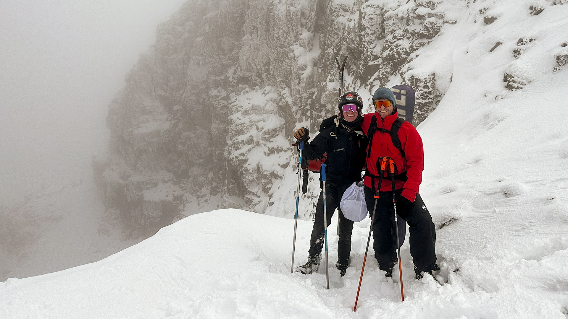 A skier and snowboarder in snow