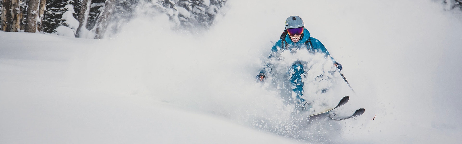 man skiing in powder