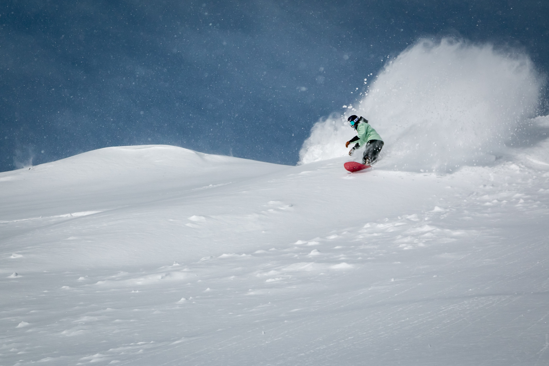 snowboarder riding powder