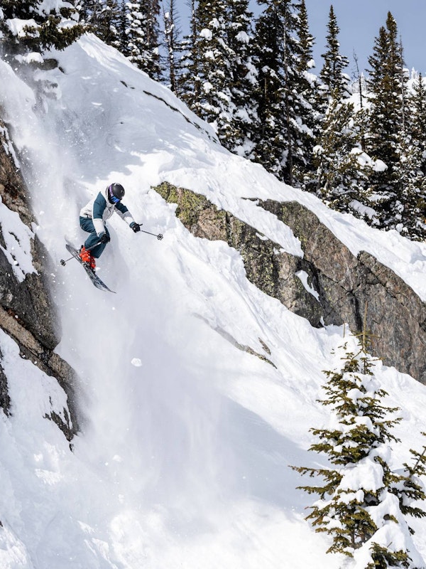 Skier jumping off a cliff