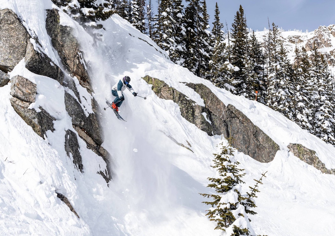 Skier jumping off a cliff
