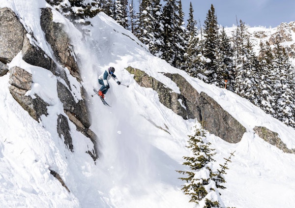 Skier jumping off a cliff