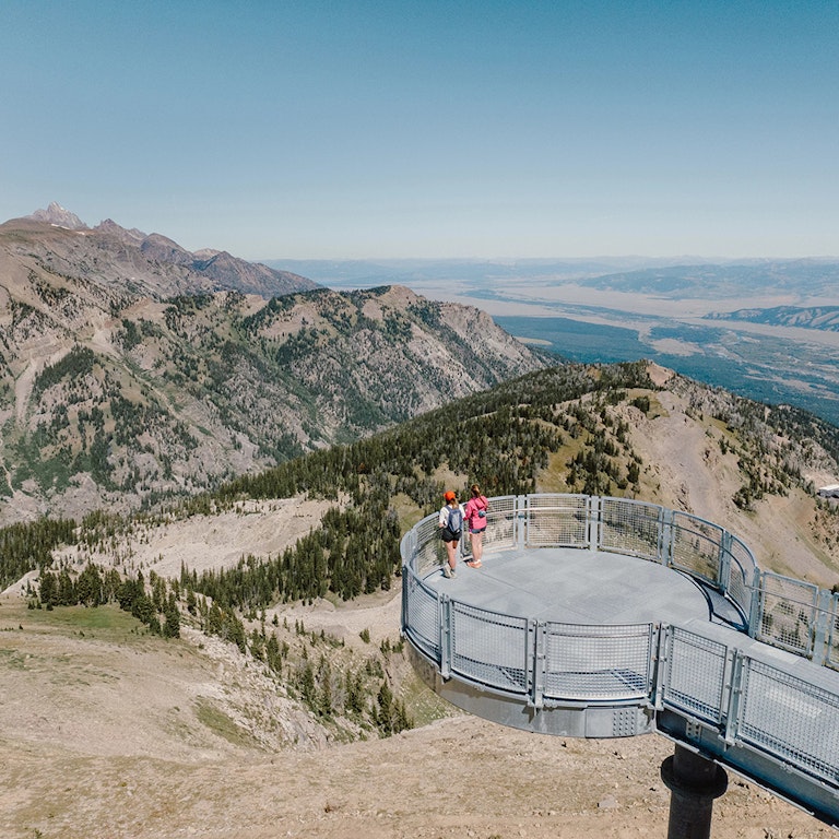 two people looking at view from Grand Teton Skywalk