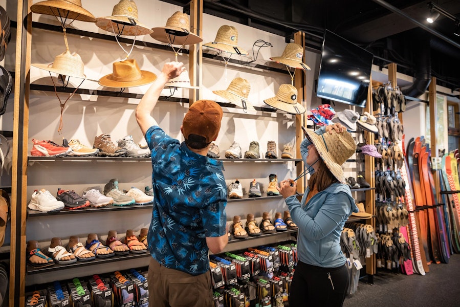 two people looking at hats in TVS