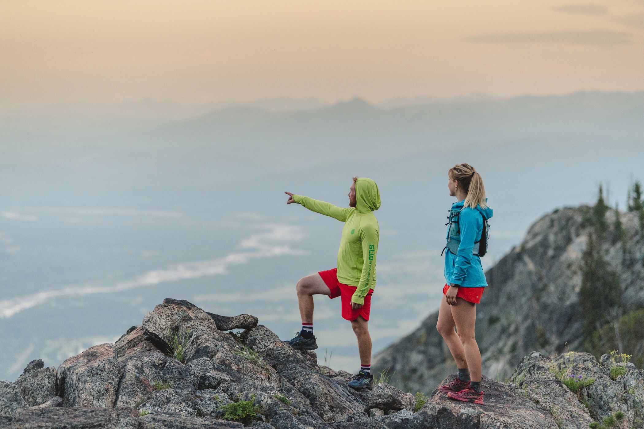 two hikers taking in sunset views
