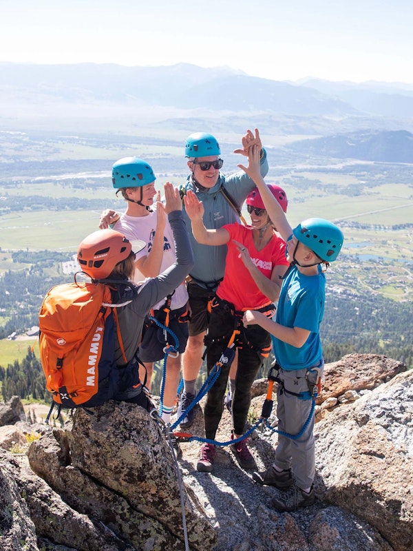 Family high fiving during the Via Ferrata