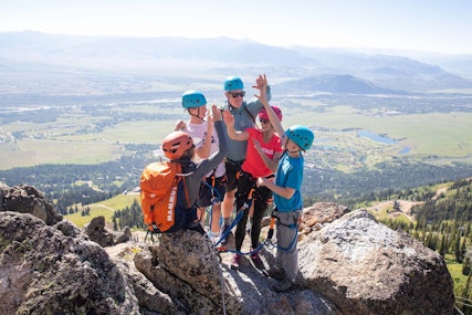 Family high fiving during the Via Ferrata