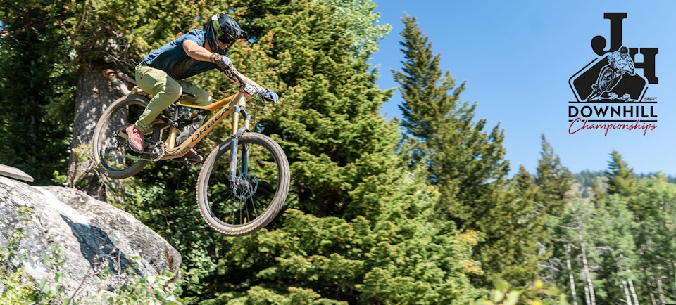Person biking in JH Bike Park with JH Downhill logo