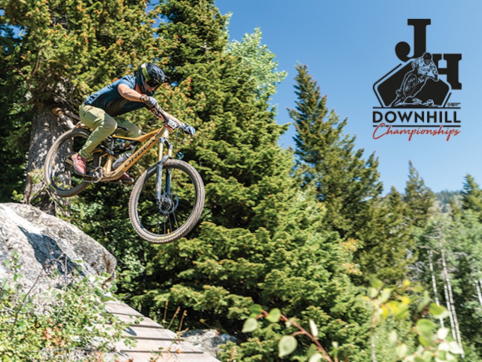 Person biking in JH Bike Park with JH Downhill logo