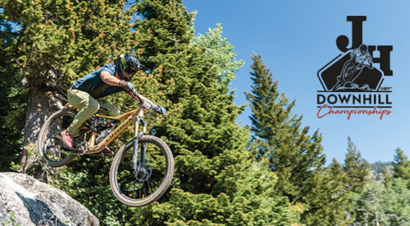 Person biking in JH Bike Park with JH Downhill logo