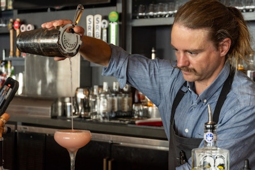 bartender making a drink at Piste