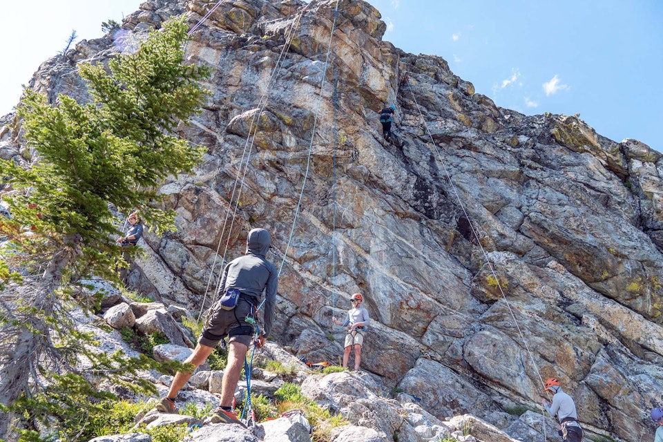 People belaying rock climbers on the wall