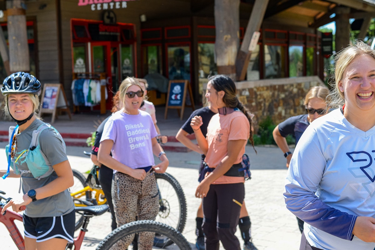 women hanging out at the base of the mountain during ILLA bike takeover