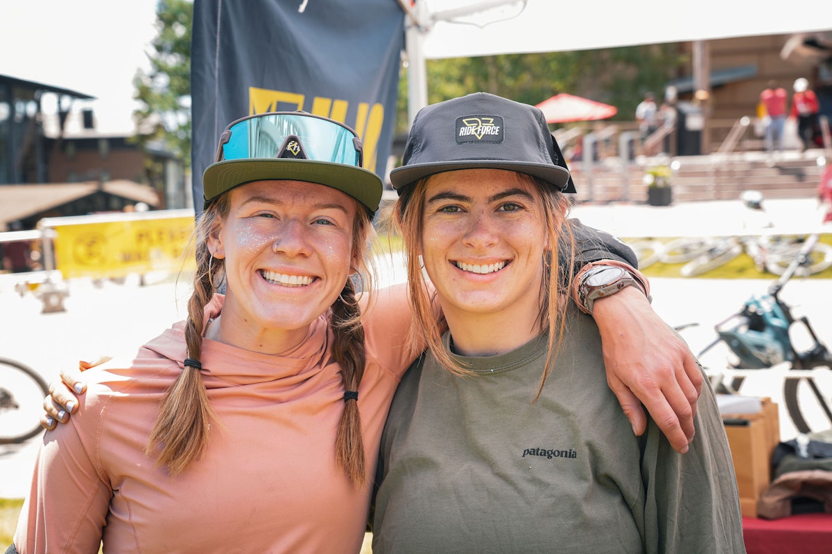 Women smiling at the base of the mountain during ILLA Bike Park takeover
