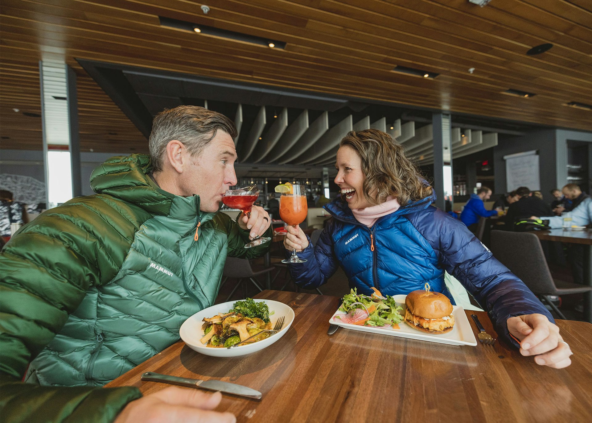 Man and women enjoying drinks at piste restaurant
