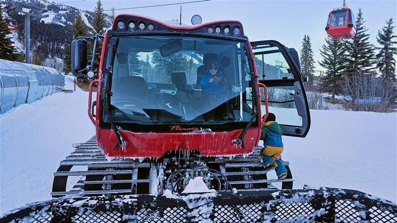 Kids playing on Snow Cats