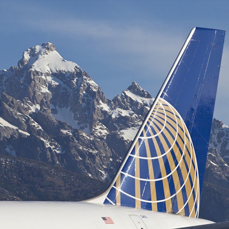 United Airplines tail with tetons in the background