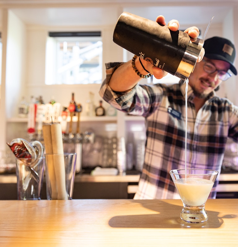 Tram Dock bartender pouring drink