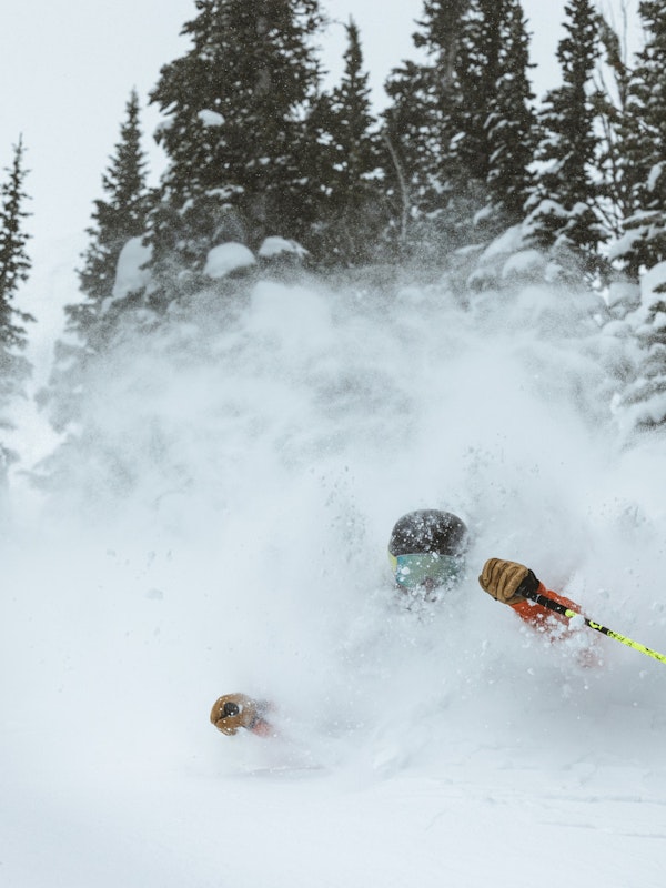 skier in making a turn in deep powder at jackson hole mountain resort