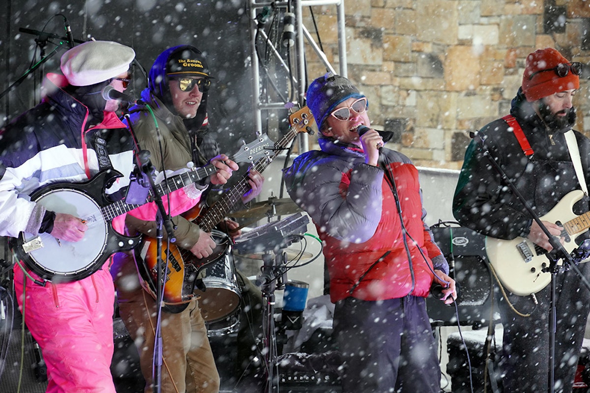 band playing under the tram in the snow