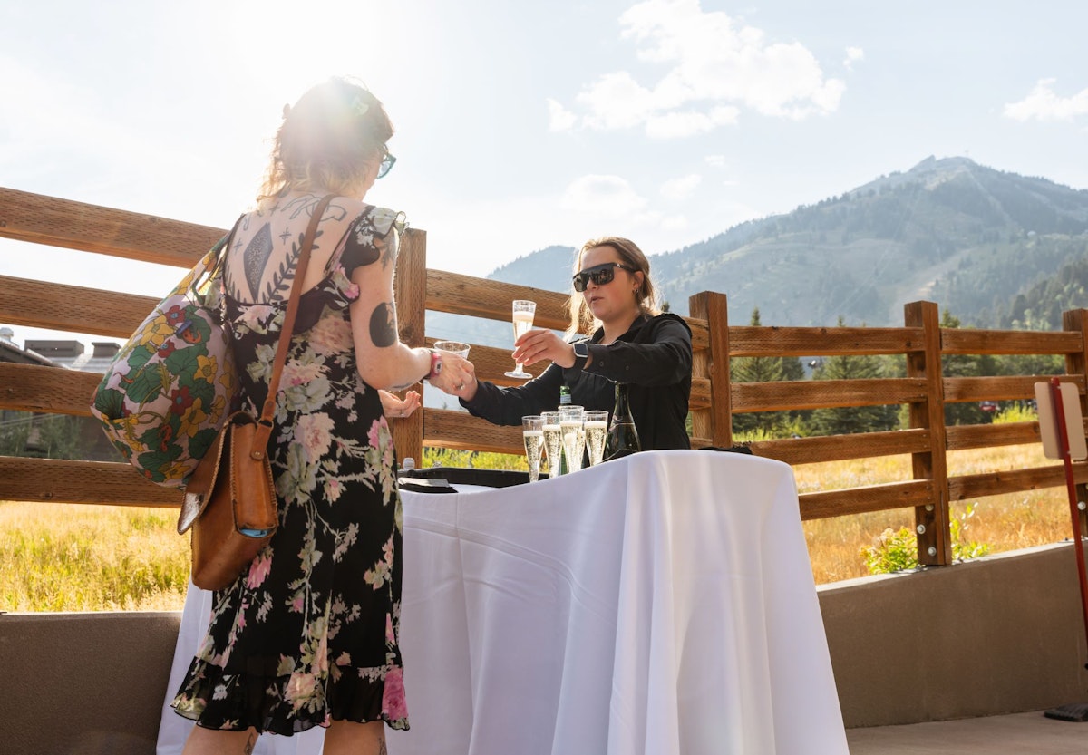 Wedding guest getting drinks from bar tender