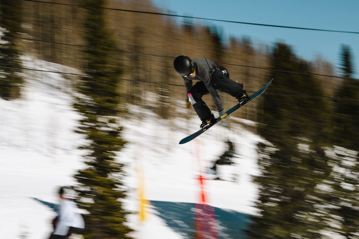 Snowboarder getting air in Dick's Ditch