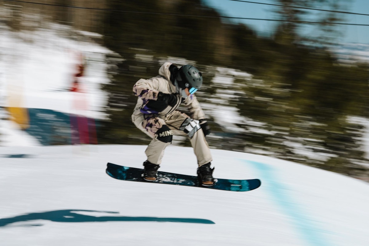 Snowboarder getting air in Dick's Ditch
