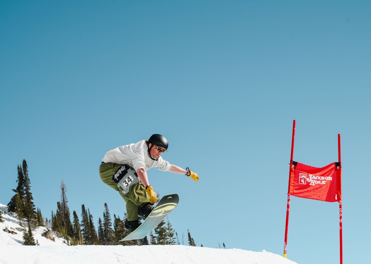 Snowboarder getting air in Dick's Ditch