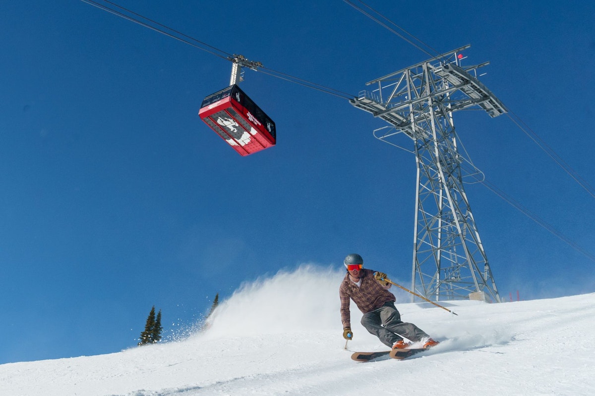 Spring skiing with tram in background