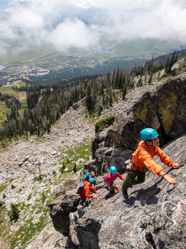 family climbing up the via ferrata at jackson hole mountain resort