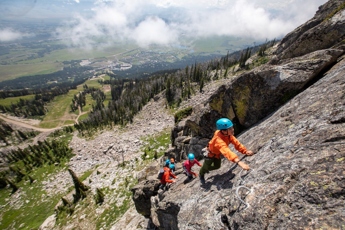 family climbing up the via ferrata at jackson hole mountain resort