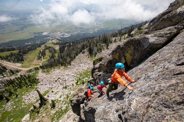 family climbing up the via ferrata at jackson hole mountain resort