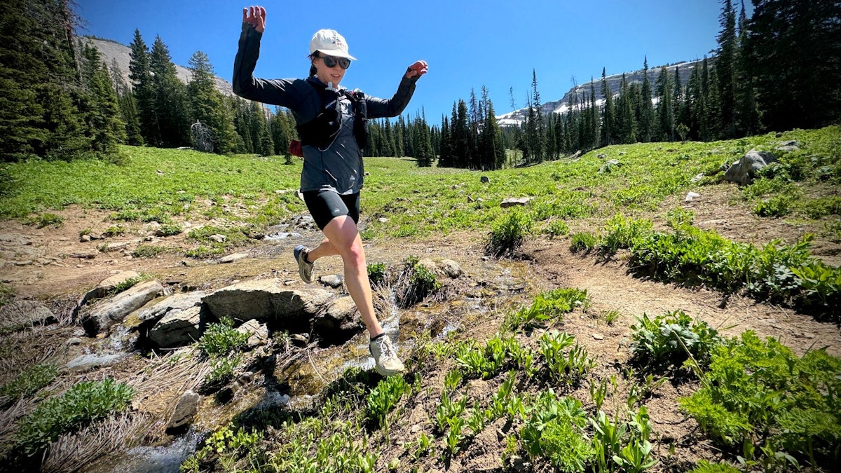 Jumping over creek while trail running grand teton np
