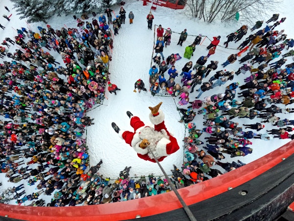 Santa Claus descending from the aerial tram on christmas day in jackson hole, wyoming