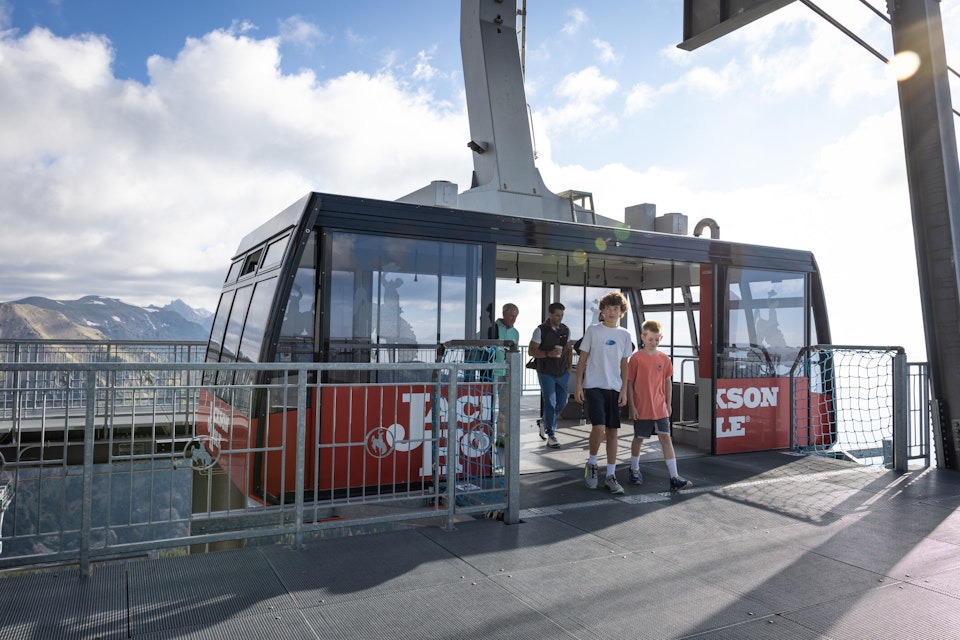 family stepping off of the aerial tram at the top of jackson hole mountian resort