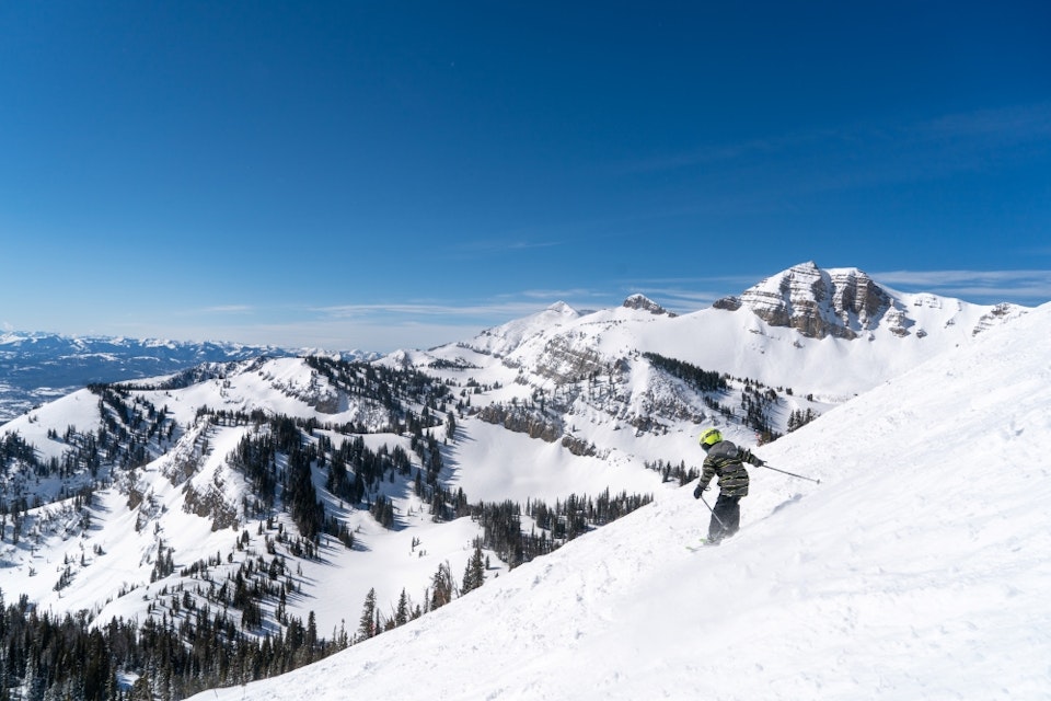 Kid skiing in front of Cody JHMR