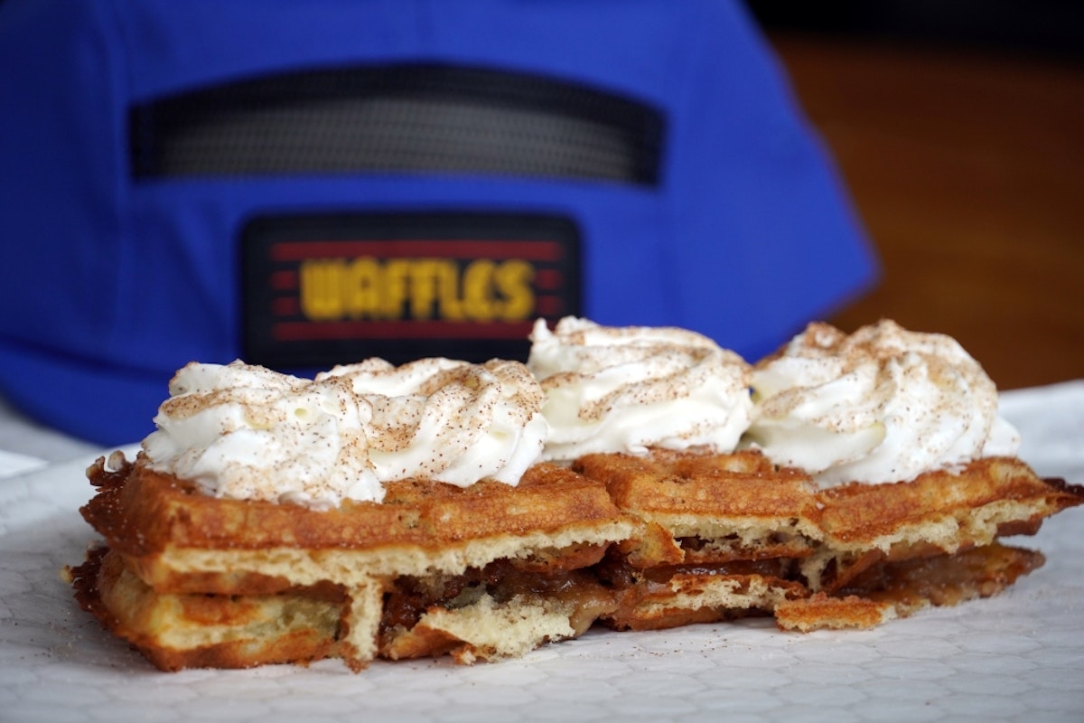 waffle sitting in front of waffles hat at corbets cabin