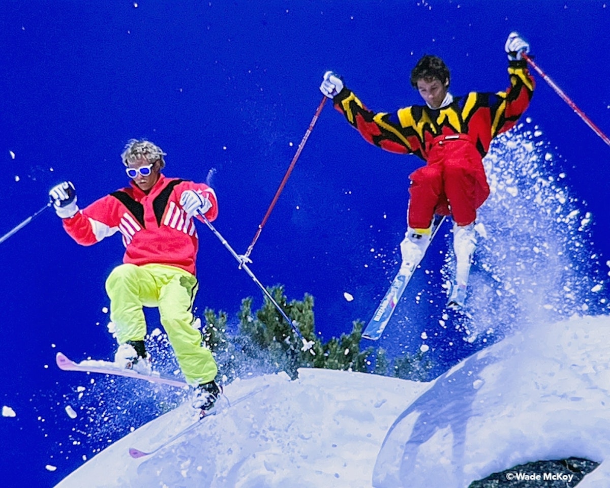 skiers jumping off cliff together
