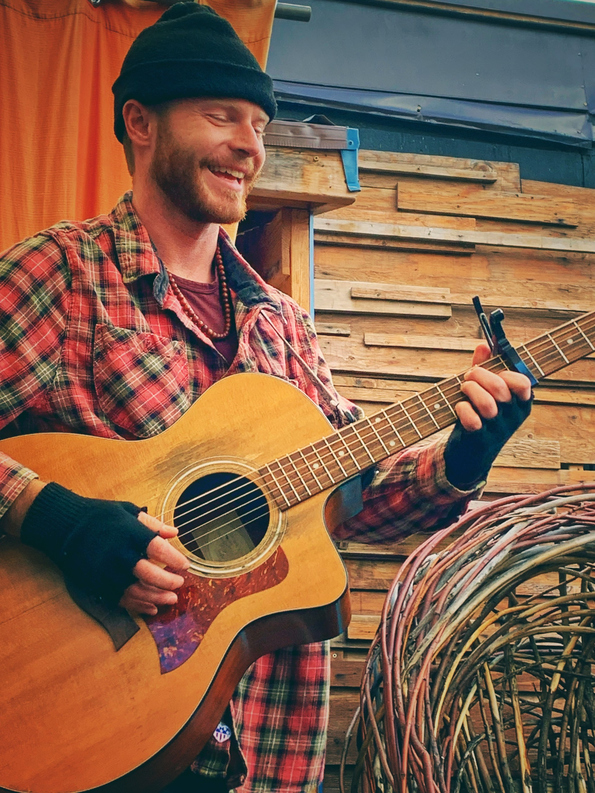 Joe Hunt smiling and playing guitar.