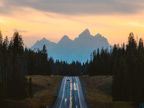 Car in front of tetons